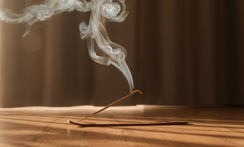 Incense being burned with the goal of interpreting its meaning