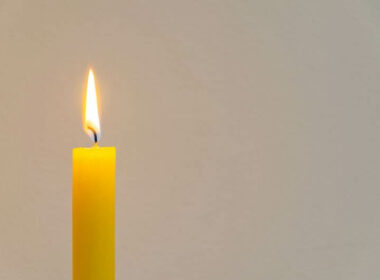 A yellow candle with an inspirational meaning